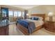 Bedroom with blue bedding, a wooden dresser and a view of the outdoor cityscape at 1125 W Peppertree Dr # 706, Sarasota, FL 34242