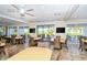 Spacious clubhouse featuring tables, chairs, ceiling fans and ocean views from many vantage points at 1125 W Peppertree Dr # 706, Sarasota, FL 34242