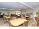 Clubhouse with tables and chairs, complimented by a kitchen bar and a lounge area for residents to enjoy at 1125 W Peppertree Dr # 706, Sarasota, FL 34242