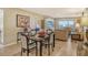Dining room with black table and seating in open concept floor plan at 1125 W Peppertree Dr # 706, Sarasota, FL 34242