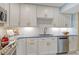 Renovated kitchen with stainless steel appliances, white cabinets, and unique countertop design at 1125 W Peppertree Dr # 706, Sarasota, FL 34242