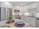 Bright kitchen featuring stainless steel appliances, white cabinets, and modern countertops at 1125 W Peppertree Dr # 706, Sarasota, FL 34242