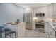 Updated kitchen with stainless steel appliances, white cabinetry, and a breakfast bar at 1125 W Peppertree Dr # 706, Sarasota, FL 34242