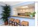 Bright kitchen featuring a breakfast bar with wicker stools and granite countertops at 1125 W Peppertree Dr # 706, Sarasota, FL 34242