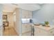Kitchenette with white cabinets and a breakfast bar next to dining room at 1125 W Peppertree Dr # 706, Sarasota, FL 34242