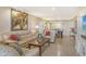 Spacious living room with leather sofas, tile floors, and adjacent dining area at 1125 W Peppertree Dr # 706, Sarasota, FL 34242