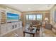 Bright living room featuring a large entertainment center and sliding glass doors to a balcony at 1125 W Peppertree Dr # 706, Sarasota, FL 34242