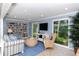 Cozy living room featuring a bookshelf, comfortable seating, and a bright window with greenery views at 1125 W Peppertree Dr # 706, Sarasota, FL 34242