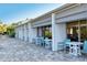 Charming patio area with tables and chairs, creating a relaxing outdoor dining space near lush landscaping at 1125 W Peppertree Dr # 706, Sarasota, FL 34242