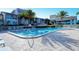 Relaxing pool area with lounge chairs, tropical landscaping, and nearby buildings at 1125 W Peppertree Dr # 706, Sarasota, FL 34242