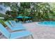 Relaxing pool deck with lounge chairs and clear blue water at 1125 W Peppertree Dr # 706, Sarasota, FL 34242