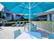 Pool deck featuring patio seating, lounge chairs, and lush tropical plants at 1125 W Peppertree Dr # 706, Sarasota, FL 34242