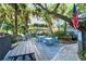 Poolside grills and picnic tables under the shade of mature trees at 1125 W Peppertree Dr # 706, Sarasota, FL 34242