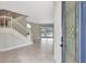 Bright foyer with staircase, tile flooring, leading to living area with a view of the pool and lake at 11254 Rivers Bluff Cir, Lakewood Ranch, FL 34202