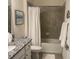 Well-lit bathroom featuring a shower-tub combo with tiled walls and a granite countertop vanity at 12229 Amica Loop, Venice, FL 34293