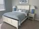 Comfortable bedroom featuring a king-size bed with stylish bedding, bedside tables and lamps and cozy carpet at 12229 Amica Loop, Venice, FL 34293