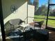 Inviting screened patio with comfortable seating and a view of lush greenery at 12229 Amica Loop, Venice, FL 34293