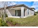Home exterior features a covered patio and well-maintained lawn at 12518 Oak Hill Way, Parrish, FL 34219