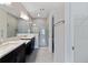 Bright bathroom features double sinks, large mirror, and a tiled walk-in shower at 12518 Oak Hill Way, Parrish, FL 34219