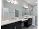 Bright bathroom features double sinks, large mirror, and a tiled walk-in shower at 12518 Oak Hill Way, Parrish, FL 34219