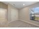 Bedroom featuring a window with a view, a double door closet, and an entrance to an adjacent room at 12518 Oak Hill Way, Parrish, FL 34219