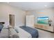 Bright bedroom features a TV and doorway leading to the ensuite bathroom at 12518 Oak Hill Way, Parrish, FL 34219