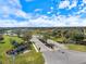 A wide street leads to a beautifully landscaped Crosswind Point community entrance with lush greenery and clear blue skies at 12518 Oak Hill Way, Parrish, FL 34219