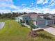 Beautiful single-story home with a gray exterior, well-kept lawn, and two-car garage at 12518 Oak Hill Way, Parrish, FL 34219