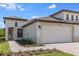 Charming home exterior features a well-kept lawn and a two-car garage at 12518 Oak Hill Way, Parrish, FL 34219