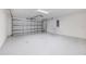 Spacious two car garage with sealed concrete flooring and bright lighting ready for parking and storage at 12518 Oak Hill Way, Parrish, FL 34219