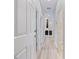 Bright hallway with neutral-toned walls and flooring, showcasing multiple doorways and access to other parts of the home at 12518 Oak Hill Way, Parrish, FL 34219