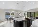 Kitchen island with sink, integrated dishwasher, and dining area at 12518 Oak Hill Way, Parrish, FL 34219