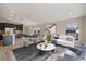 Open-concept living area features a sofa, modern decor, and ample natural light at 12518 Oak Hill Way, Parrish, FL 34219