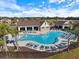 Aerial view of a community pool with lounge chairs and covered seating area at 12518 Oak Hill Way, Parrish, FL 34219