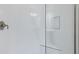 Modern shower featuring white subway tile walls, glass enclosure, and chrome fixtures for a clean, minimalist look at 12518 Oak Hill Way, Parrish, FL 34219