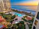 Aerial view of the resort-style pool and beach access in this luxury high-rise condominium complex at 1281 Gulf Of Mexico Dr # 703, Longboat Key, FL 34228