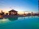 Beautiful pool with a gazebo overlooking the ocean at sunset for a tranquil resort atmosphere at 1281 Gulf Of Mexico Dr # 703, Longboat Key, FL 34228