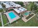 Aerial view of community pool, shuffleboard court and bocce ball court with condo buildings at 1330 Glen Oaks E Dr # 174D, Sarasota, FL 34232