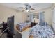 Bedroom features twin beds, a ceiling fan, and a dresser at 1330 Glen Oaks E Dr # 174D, Sarasota, FL 34232