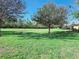 Picturesque backyard with a serene pond and mature trees, offering a peaceful and natural environment at 13602 Abercrombie Dr, Englewood, FL 34223
