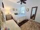 Cozy bedroom with wood style flooring and a comfortable bed, offering a relaxing retreat at 13602 Abercrombie Dr, Englewood, FL 34223