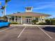 Exterior view of the community clubhouse, featuring a welcoming entrance and ample parking at 13602 Abercrombie Dr, Englewood, FL 34223