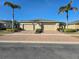 Charming paired villa featuring a brick drive, two-car garage, and manicured landscaping at 13602 Abercrombie Dr, Englewood, FL 34223