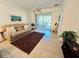 Comfortable living room featuring tile flooring, neutral walls, ceiling fan, and outside views at 13602 Abercrombie Dr, Englewood, FL 34223