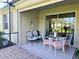 Charming screened patio with stylish furniture and a cozy atmosphere, ideal for enjoying the outdoors at 13602 Abercrombie Dr, Englewood, FL 34223