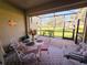 Inviting screened-in patio with comfortable seating and lovely views, perfect for relaxing and entertaining outdoors at 13602 Abercrombie Dr, Englewood, FL 34223