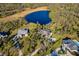 Aerial shot showcasing the home's expansive lot, private lake access and lush surroundings at 13648 Heritage Way, Sarasota, FL 34240