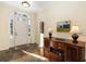 Elegant foyer with a decorative mirror, wall art, and a charming hardwood floor at 13648 Heritage Way, Sarasota, FL 34240