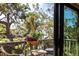 Inviting balcony with wicker furniture and scenic views of lush greenery and waterfront at 1531 Clower Creek Dr # Ha245, Sarasota, FL 34231