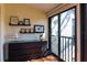 Bedroom with a dresser and access to a private balcony with scenic views at 1531 Clower Creek Dr # Ha245, Sarasota, FL 34231